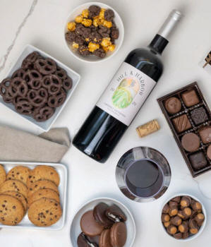 Alternative image 1 for A gift set featuring a bottle of California Pinot Noir with chocolate pretzels, caramel popcorn, mini cookies, chocolate peanut butter buckeyes, 6 chocolate-covered Oreos and a box of assorted chocolates for a luxurious touch.