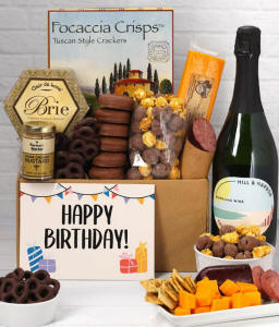 A gift set featuring a bottle of California Sparkling Wine, focaccia crisps, two cheeses, mustard, summer sausage, caramel popcorn, chocolate pretzels, six chocolate-covered Oreos and a Birthday card to complete the gourmet experience.