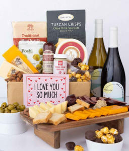 A luxurious gift box with a bottle of Hill &amp; Harbor Pinot Noir, three cheeses, gourmet crackers, summer sausage, marinated olives, smoked almonds, stone-ground mustard, chocolate-covered, and a pink 'I Love You So Much' card
