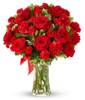 Red roses and carnations in a clear vase delivered to Indiana